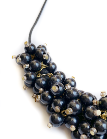 Glossy black beaded statement necklace with matching earrings.