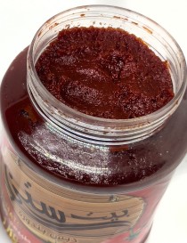 1kg jar of Beit Sitti Tomato Molasses with fresh tomato graphics.