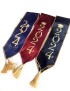 Close-up of maroon and blue satin graduation stoles with gold Arabic calligraphy and tassels.
