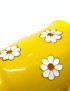 Hand-painted yellow ceramic mug with white daisy floral design and decorative handle.
