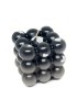 Handmade matte black bubble cube candle with silver leaf accents on a white background.