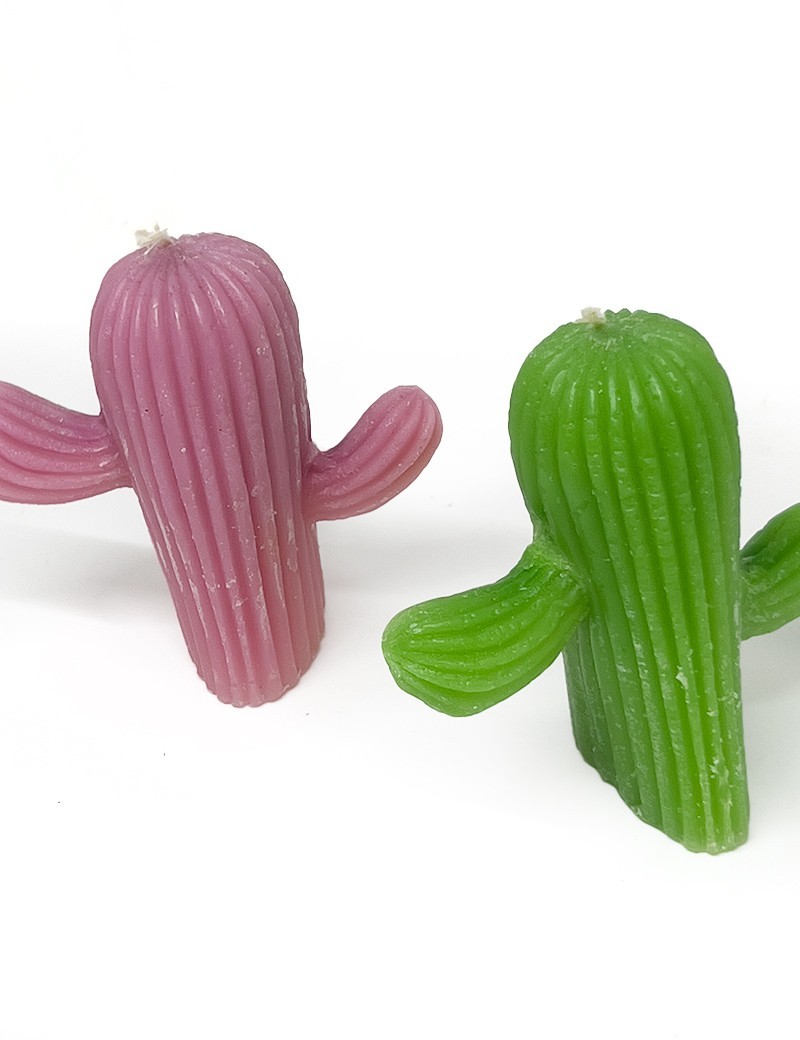 Close-up of a pink and Green saguaro cactus-shaped pillar candle with visible wick.