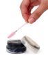 Applying Black Ever eyebrow wax with a pink spoolie brush for lash and brow styling.