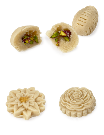 A cross-section of a molded almond marzipan sweet showing a generous filling of vibrant green pistachios.