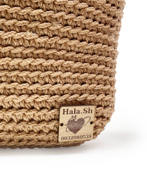 Wooden Hala.Sh brand tag stitched to the crochet exterior.