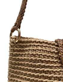 Close-up of the gold-tone ring and woven shoulder strap.
